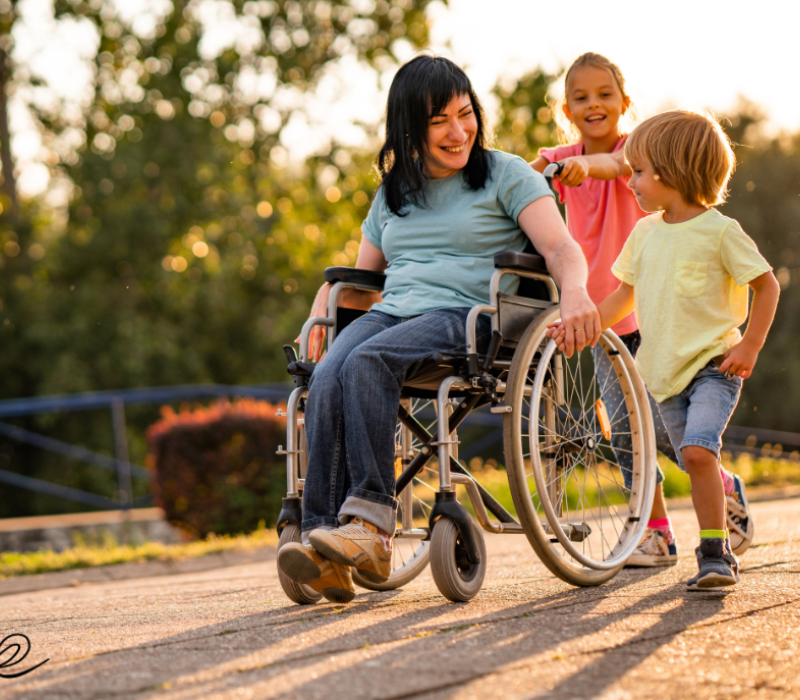 A woman in a wheelchair with two children.