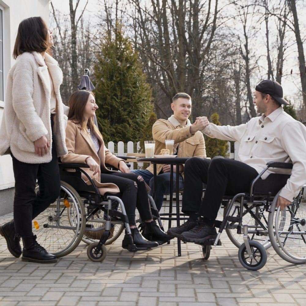 A group of people sitting around each other.